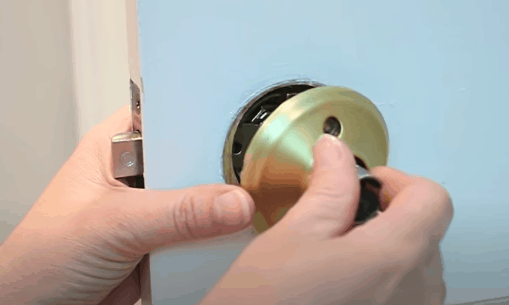 Insert the other half of the doorknob in through the other side of the latch